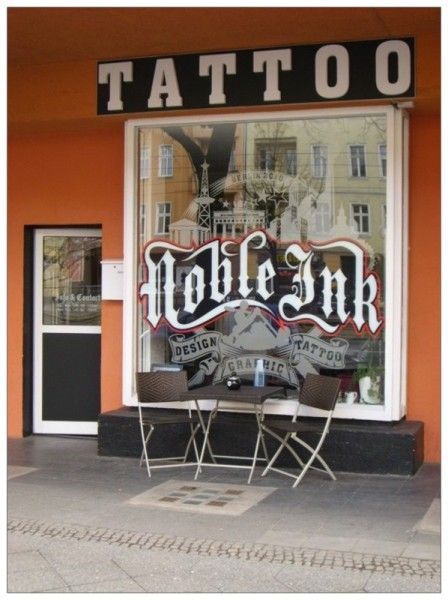 a restaurant with a sign that says cover-up tattoo, berlin, germany