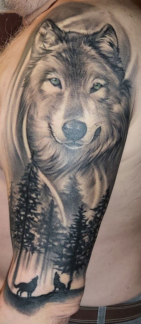 a man with a wolf cover-up tattoo on his shoulder, soest, germany