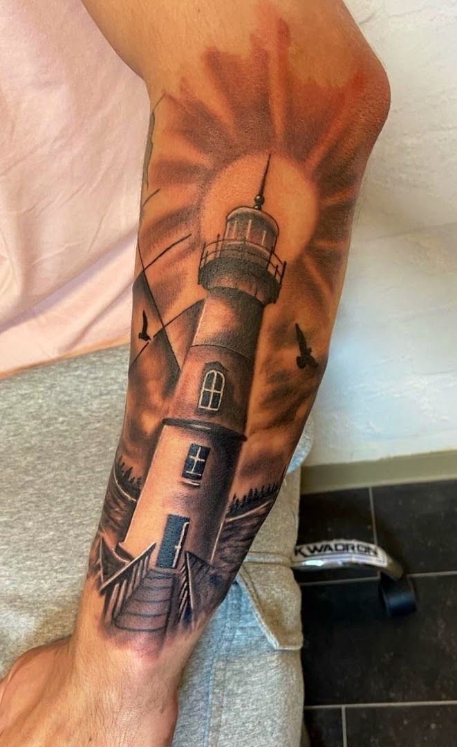 a lighthouse narben tattoo on the leg, hamburg, germany