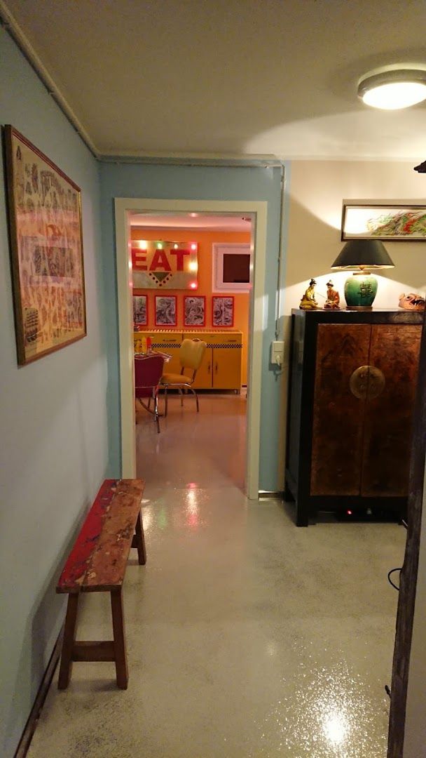 a hallway with a bench and a painting on the wall