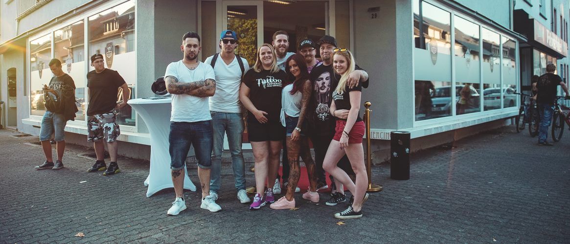 a group of people standing outside of a food truck