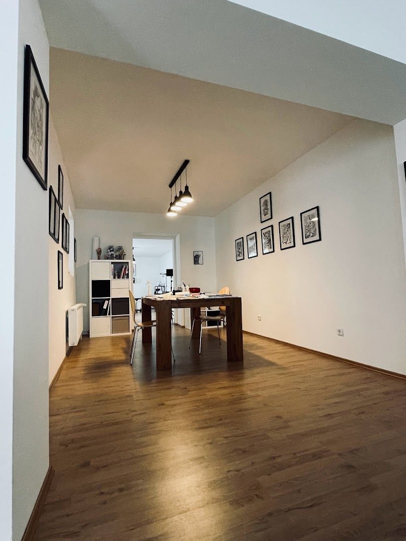 a room with a wooden floor and white walls