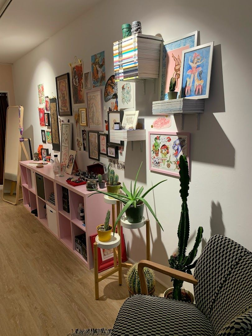 a room with a couch, chair and shelves