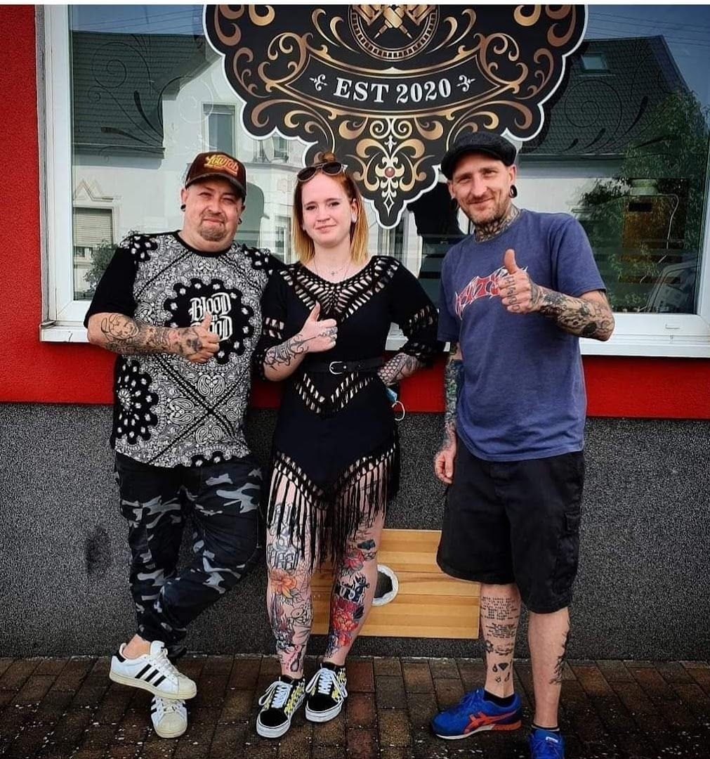 two people posing for a photo in front of a store