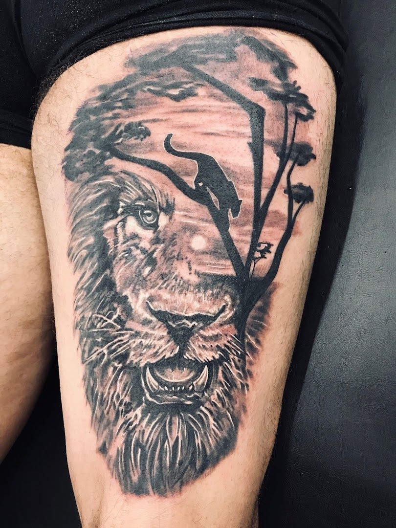 a black and grey lion cover-up tattoo on the leg, kreisfreie stadt heilbronn, germany