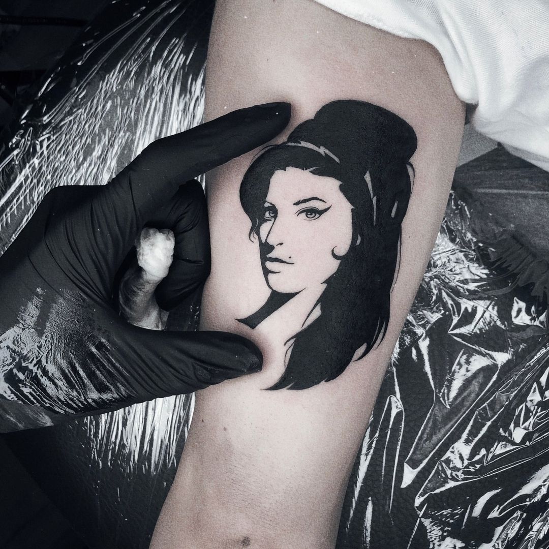 a woman's face with a black and white cover-up tattoo, berlin, germany