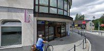 a person walking down a street next to a building