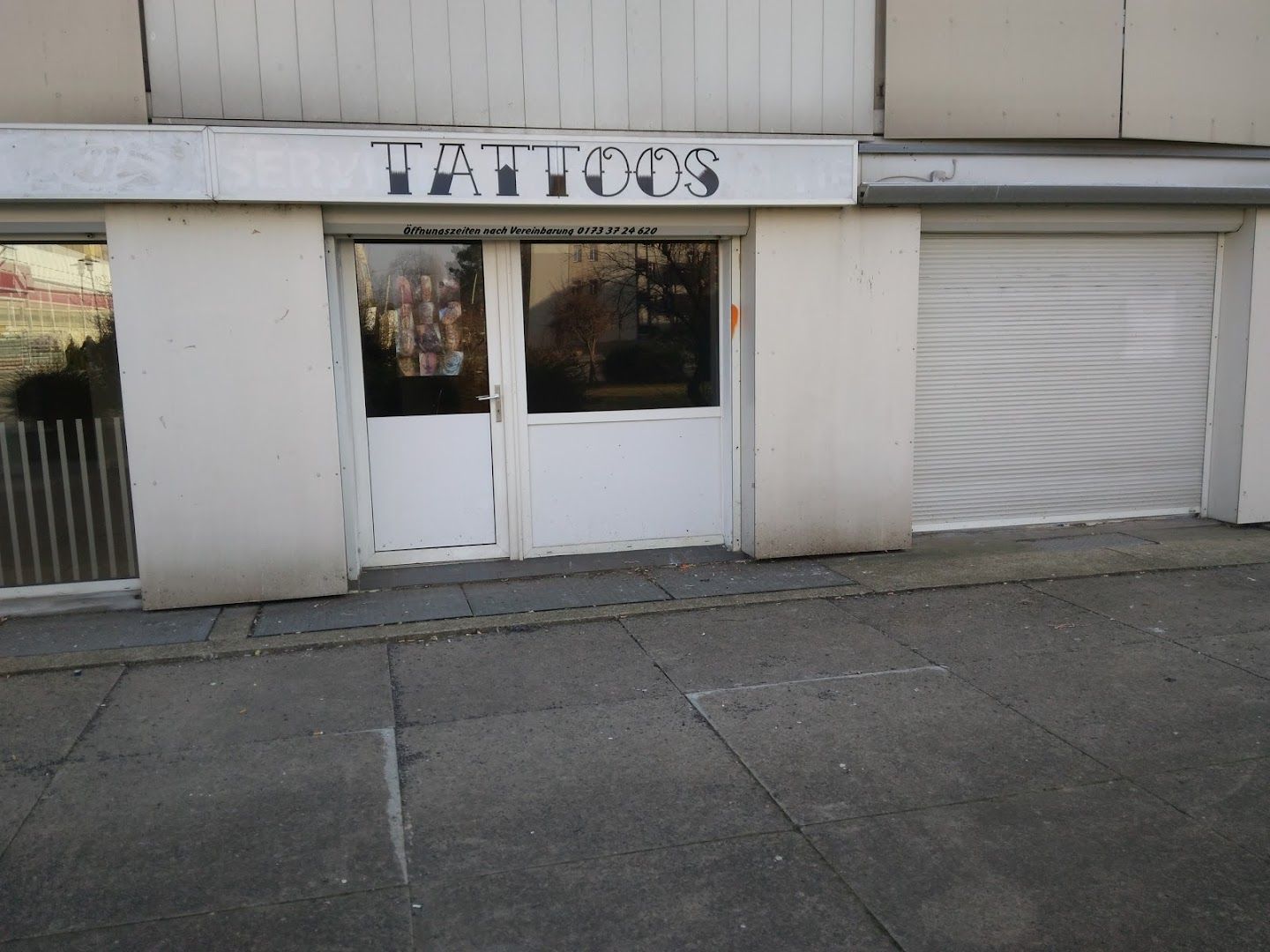 a building with a closed door and a sign on the door