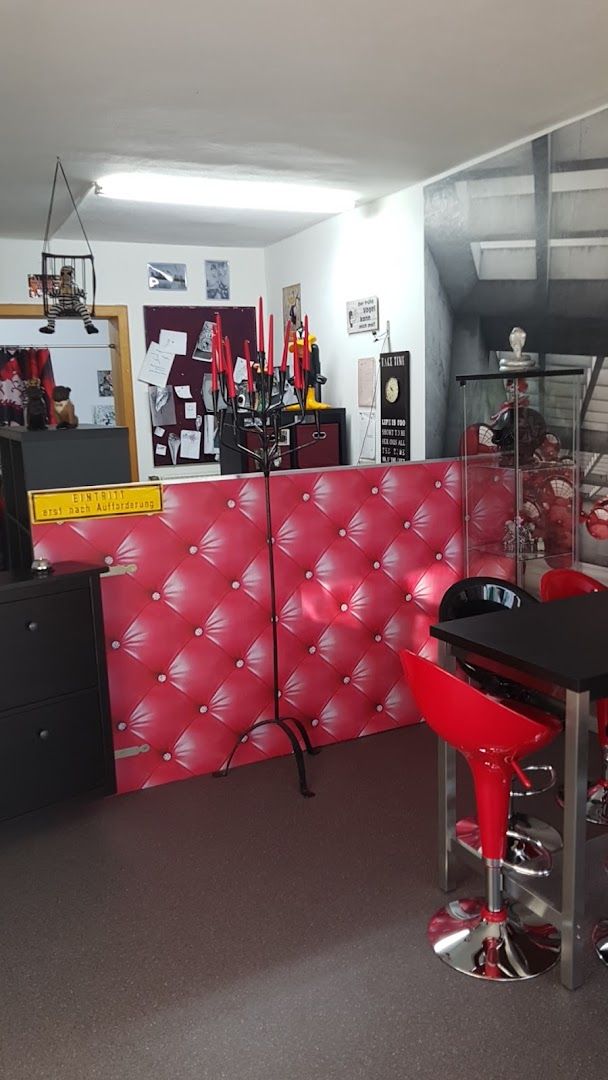 a room with a red wall and a black table