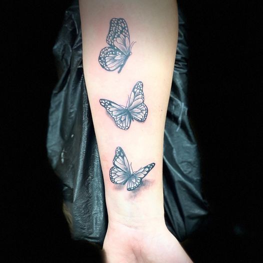 a woman's foot with a narben tattoo of two butterflies, kreisfreie stadt ingolstadt, germany