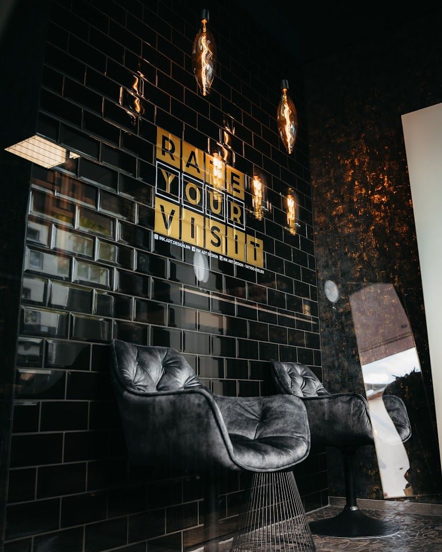 a black and white tiled wall with a black chair and a black chair