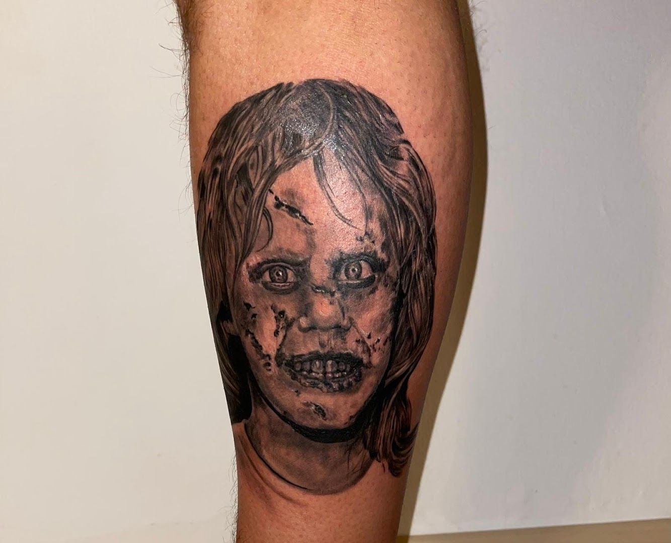 a bedeutung der tribal tattoos of a woman with a face and a skull on her leg, main-kinzig-kreis, germany