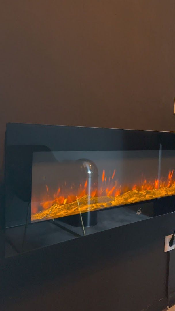 a fireplace with a glass door and a fire place