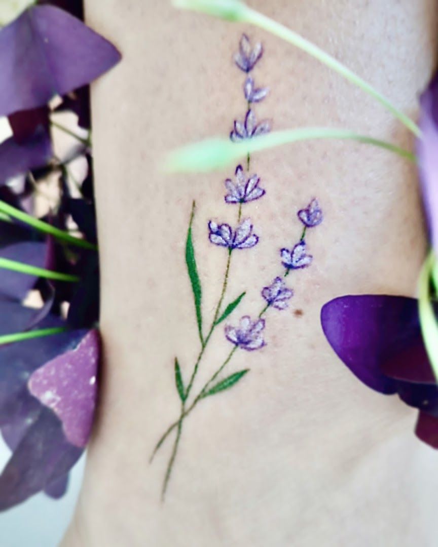 a small narben tattoo with purple flowers on the side, giessen, germany