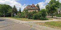 a street with a house and trees