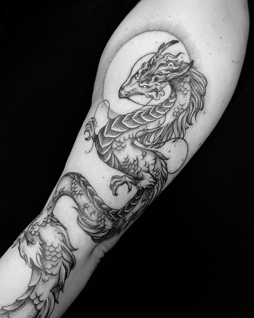 a cover-up tattoo of a dragon on the arm, saarlouis, germany