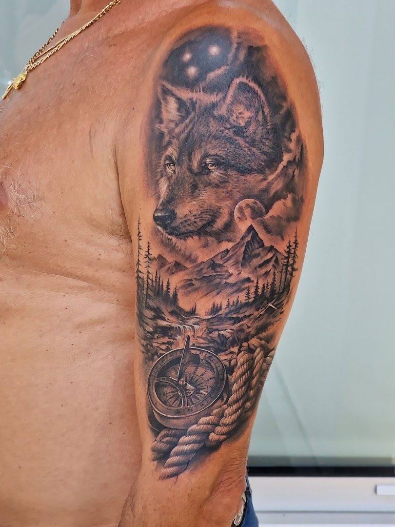 a man with a wolf cover-up tattoo on his arm, munich, germany