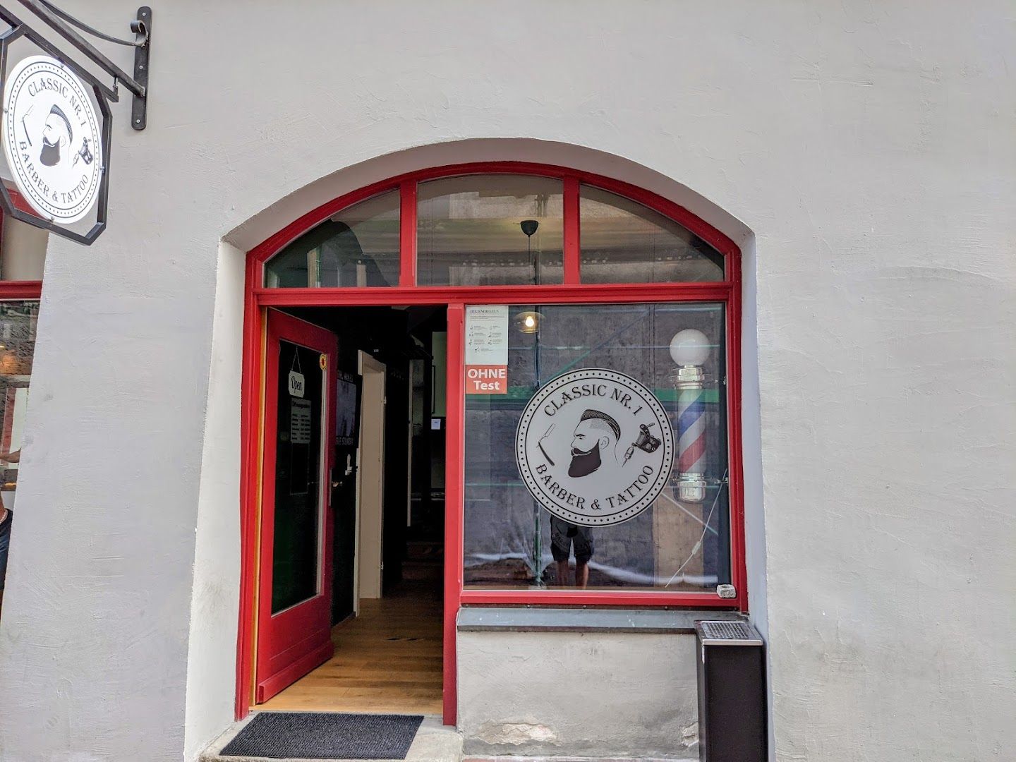 the front door of the restaurant, with a sign that says,'the restaurant is open '