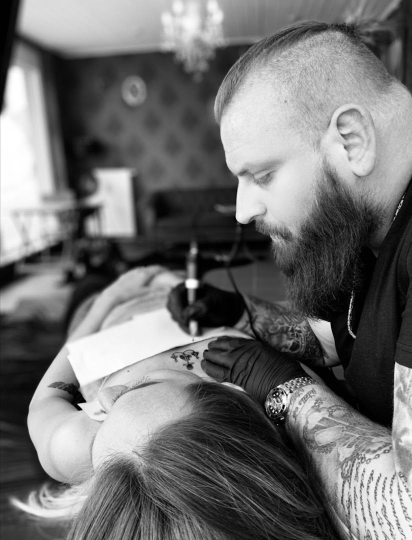 a man with a beard is getting his hair cut