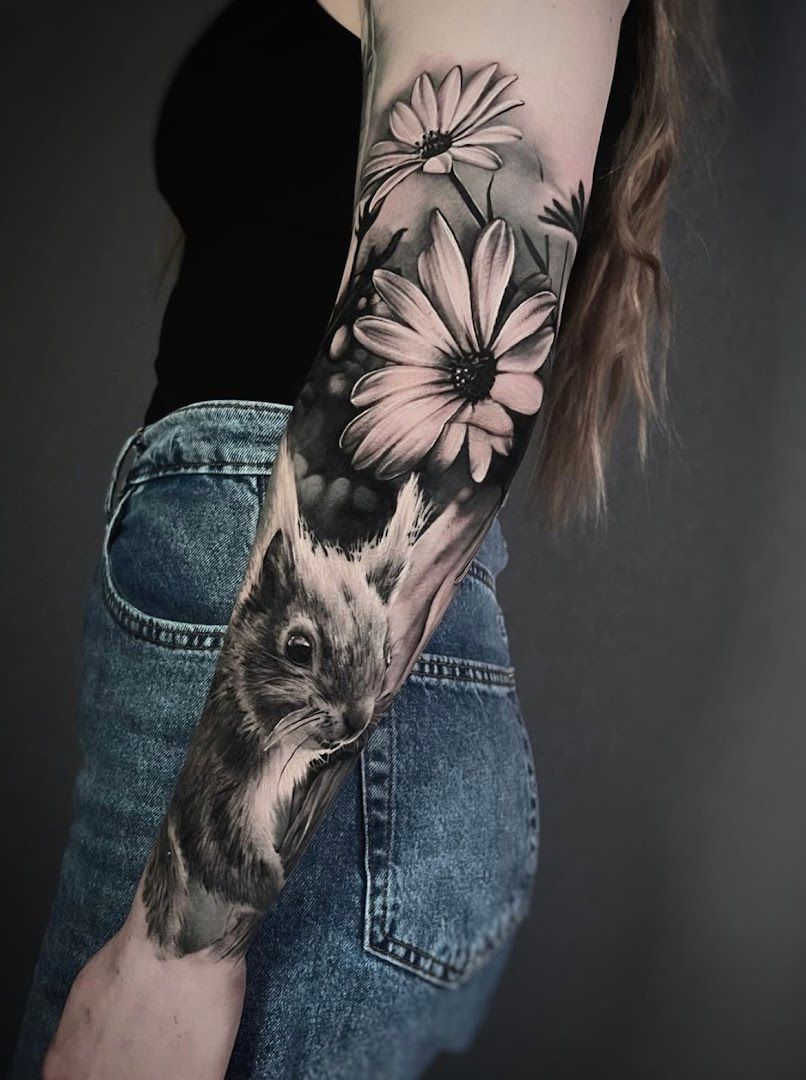 a woman's arm with a cover-up tattoo of a rabbit and flowers, bergstraße, germany