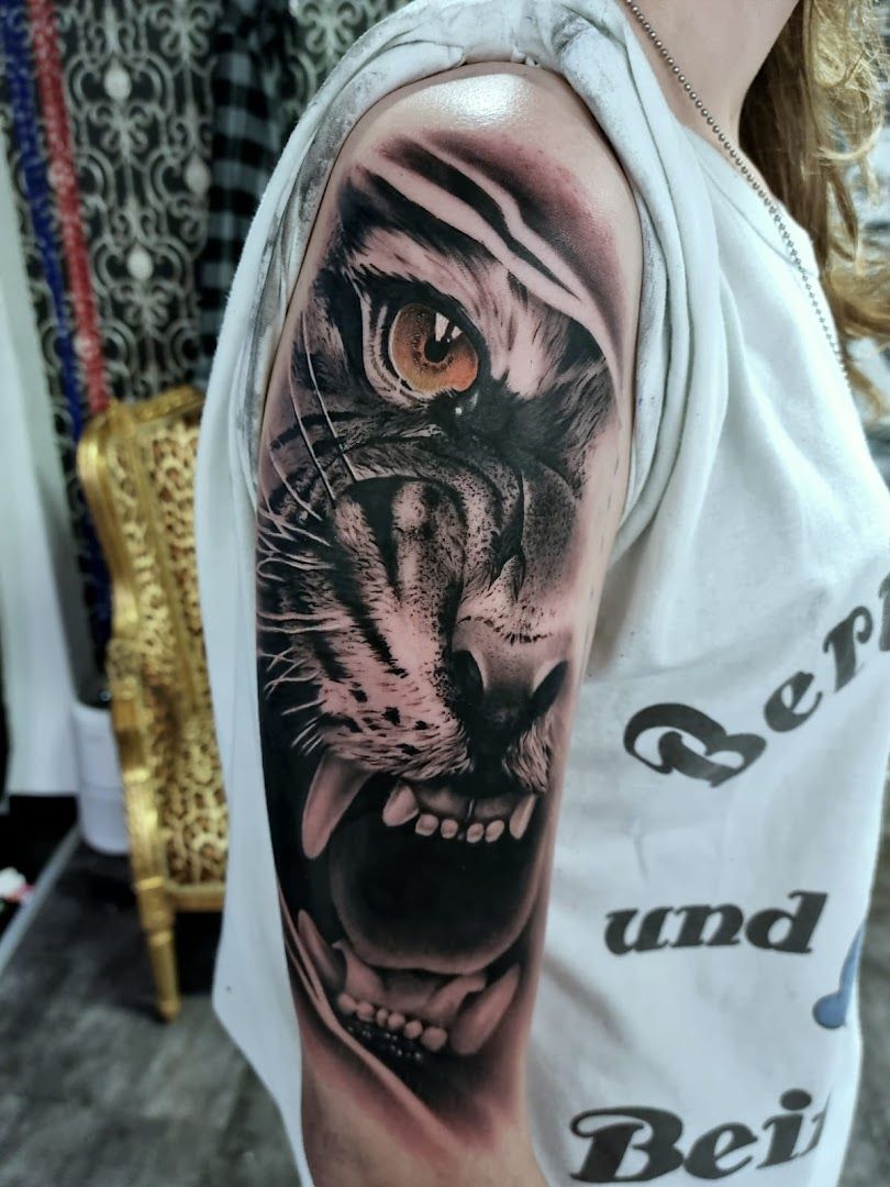 a black and white tiger cover-up tattoo on the arm, bad kreuznach, germany