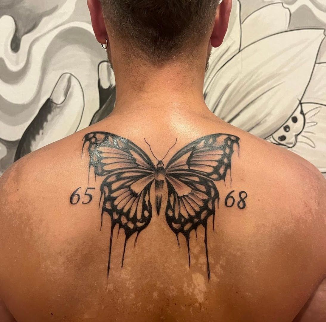 a man with a butterfly narben tattoo on his back, rosenheim, germany