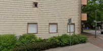 a building with a brick wall and a sidewalk