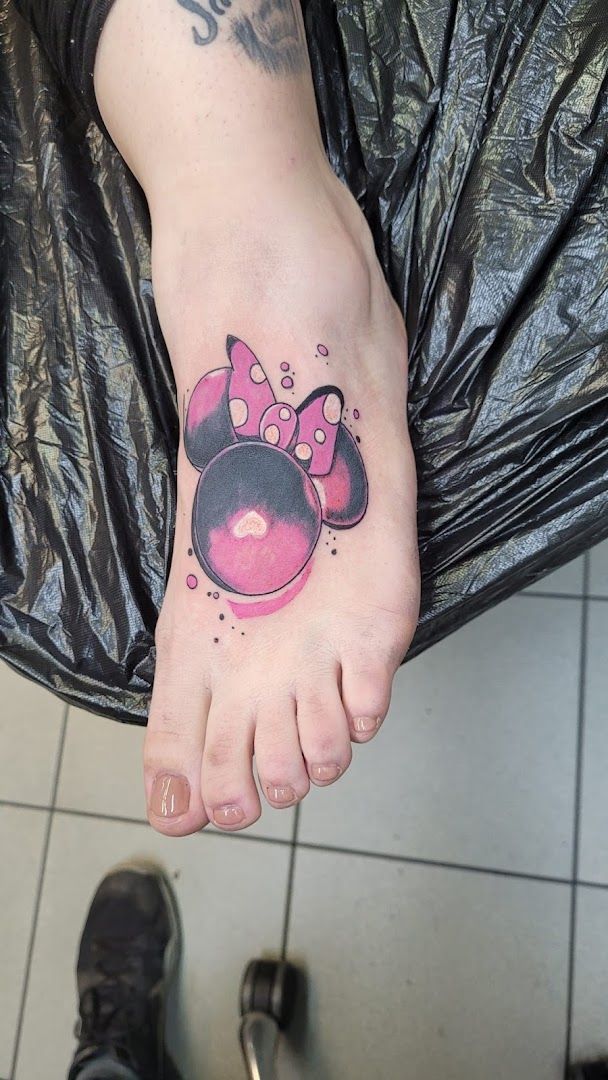 a narben tattoo of a minnie mouse on the foot, nürnberg, germany