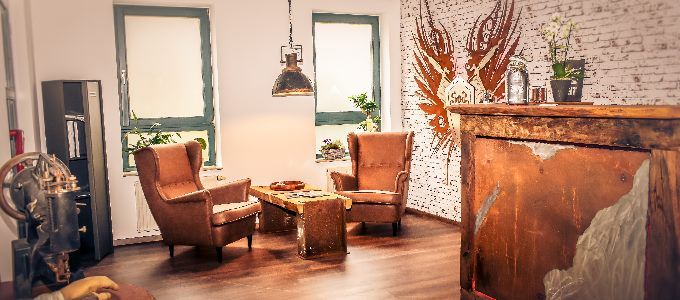 a living room with a brick wall and wooden floors