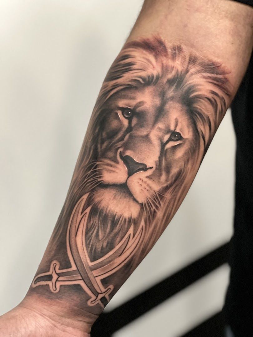 a lion with a heart cover-up tattoo on the forearm, berlin, germany