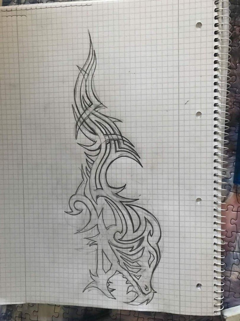 a sketch of a dragon on a piece of paper