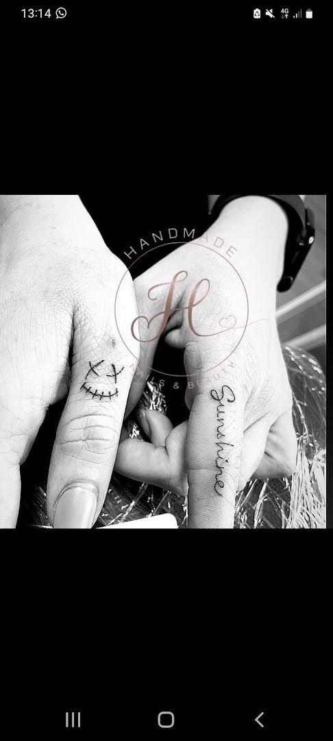 a couple holding hands with narben tattoos on them, euskirchen, germany