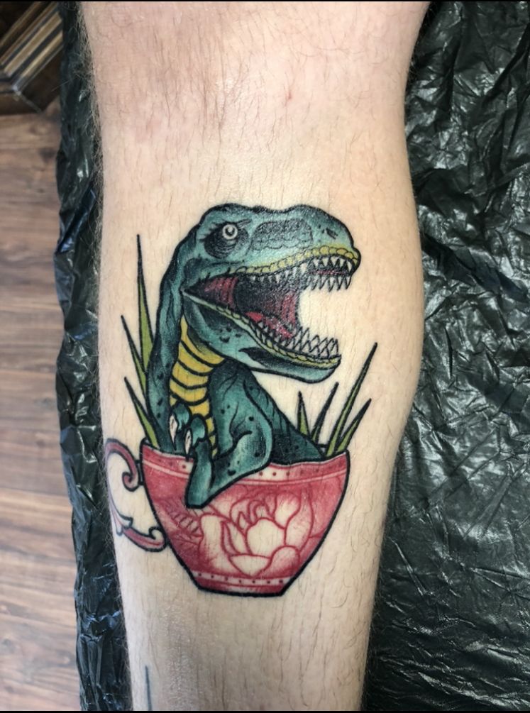 a dinosaur in a cup cover-up tattoo, darmstadt-dieburg, germany