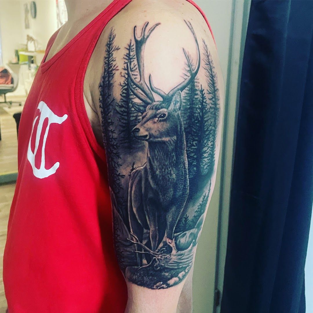 a man with a deer cover-up tattoo on his arm, nürnberg, germany