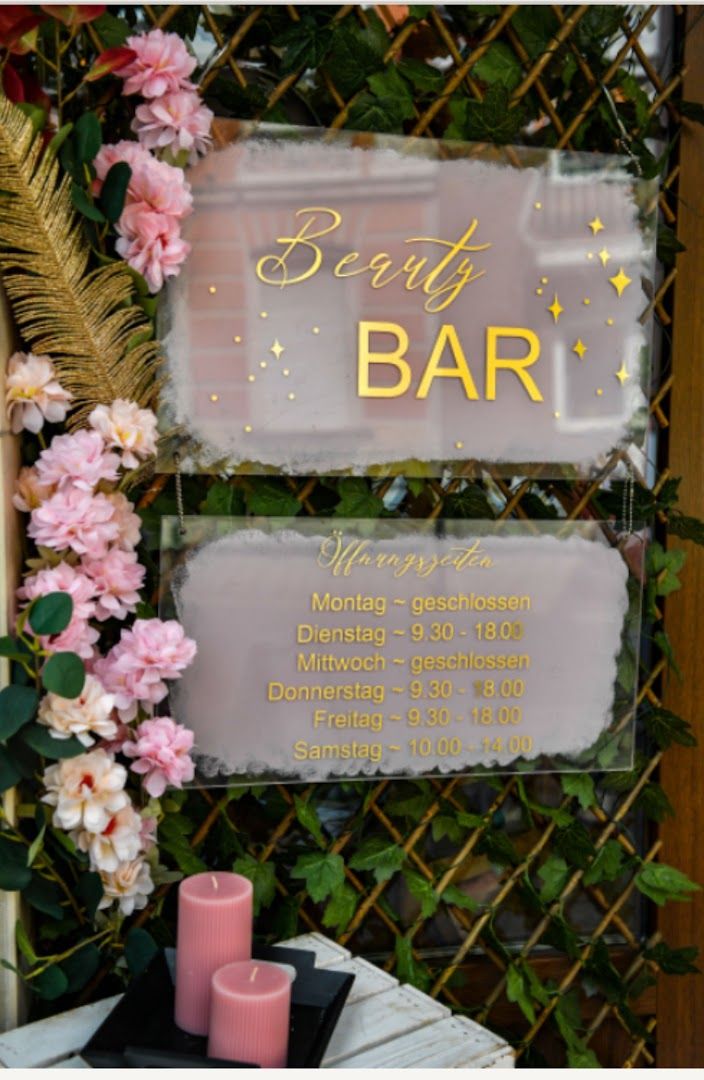 a sign that says eat bar with flowers and candles