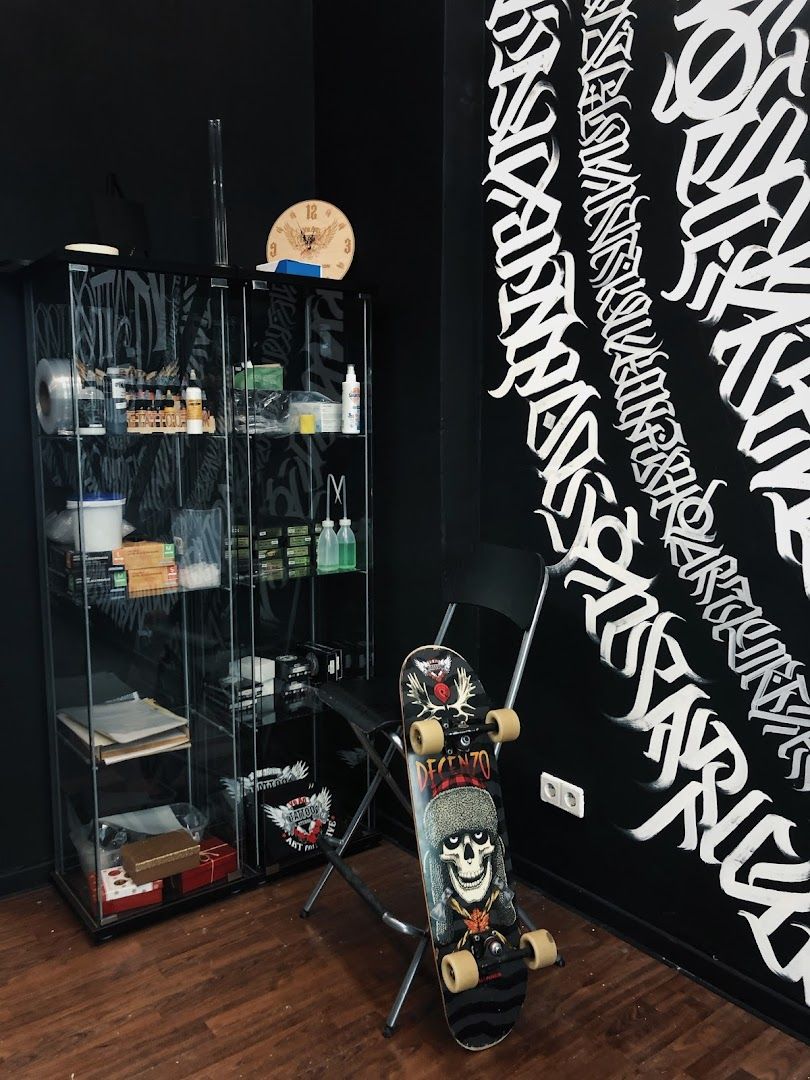 a skateboarder's room with a black wall and a black wall with graffiti written on