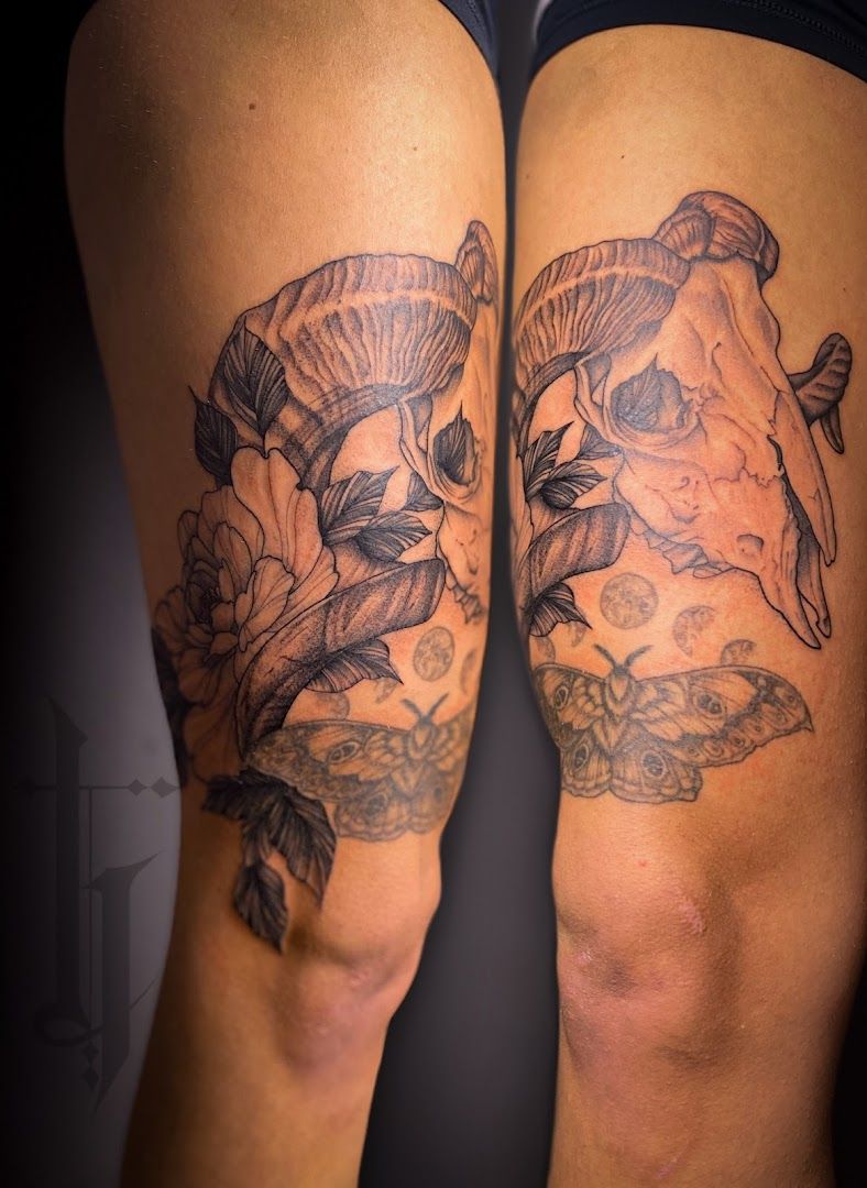 a woman's thigh with a narben tattoo of a flower and a butterfly, schwalm-eder-kreis, germany