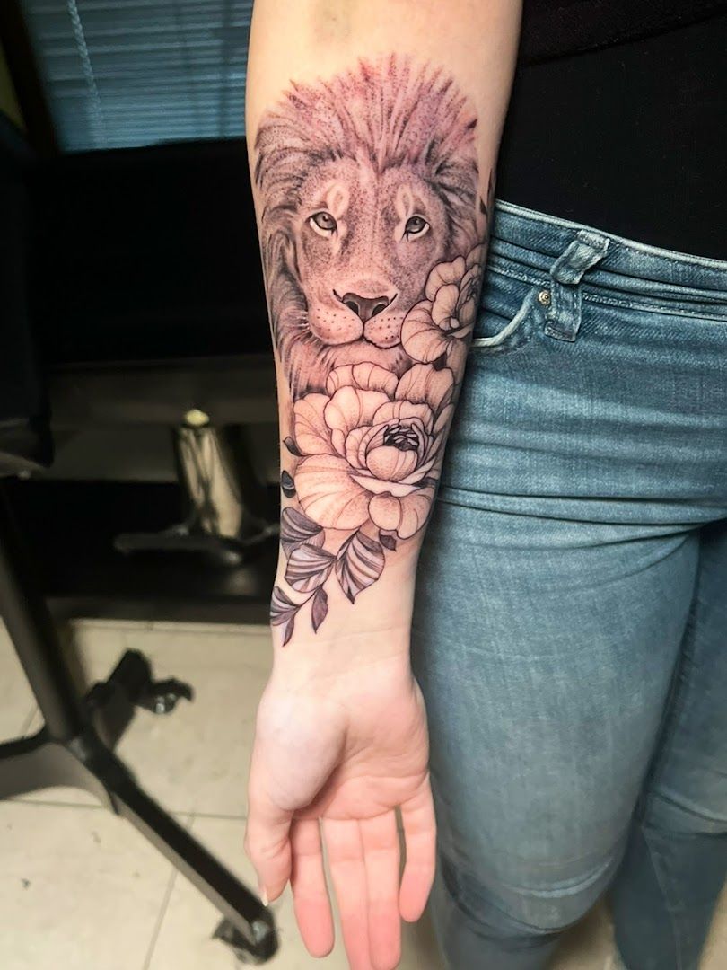 a lion with flowers on his arm