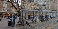 a street with buildings and people walking on it