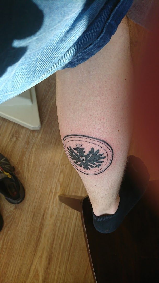 a cover-up tattoo of a bird on the leg, fulda, germany