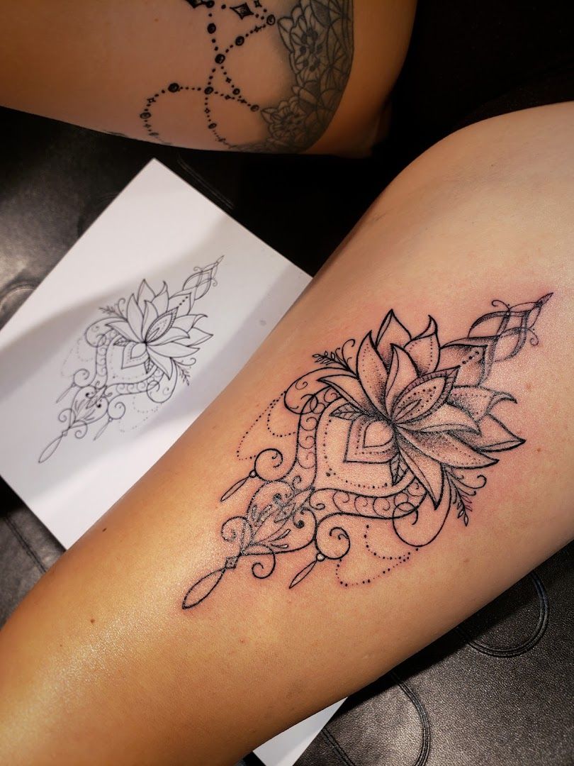 a narben tattoo design with a lotus flower on the thigh, dresden, germany