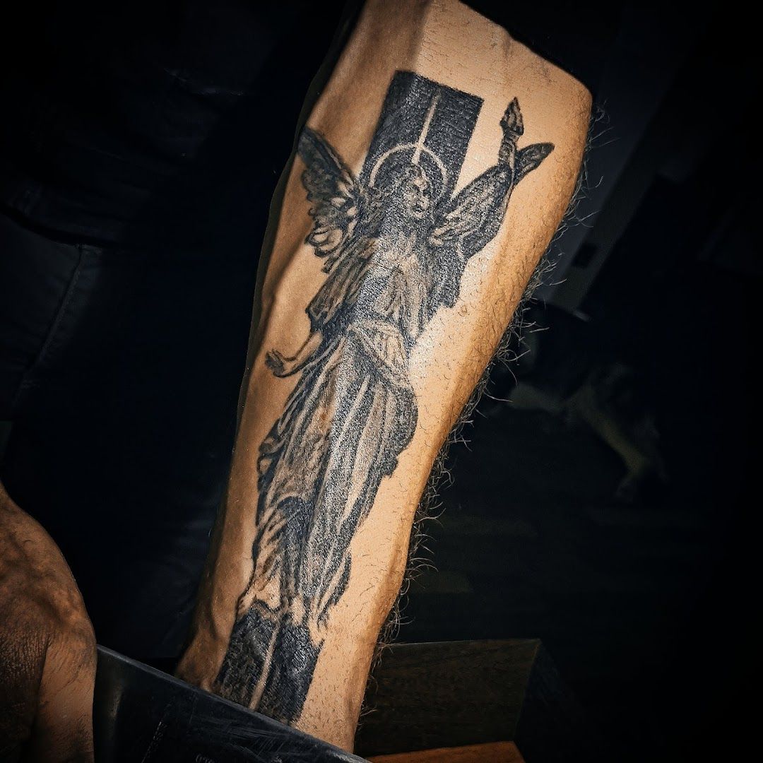 a narben tattoo of a man with a cross on his arm, neumarkt, germany