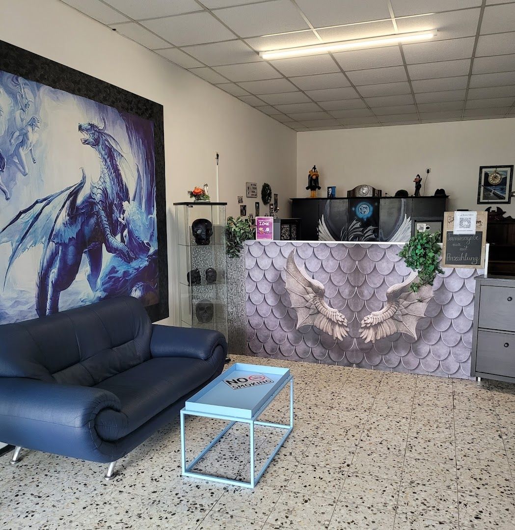 a blue couch sitting in a room with a painting on the wall