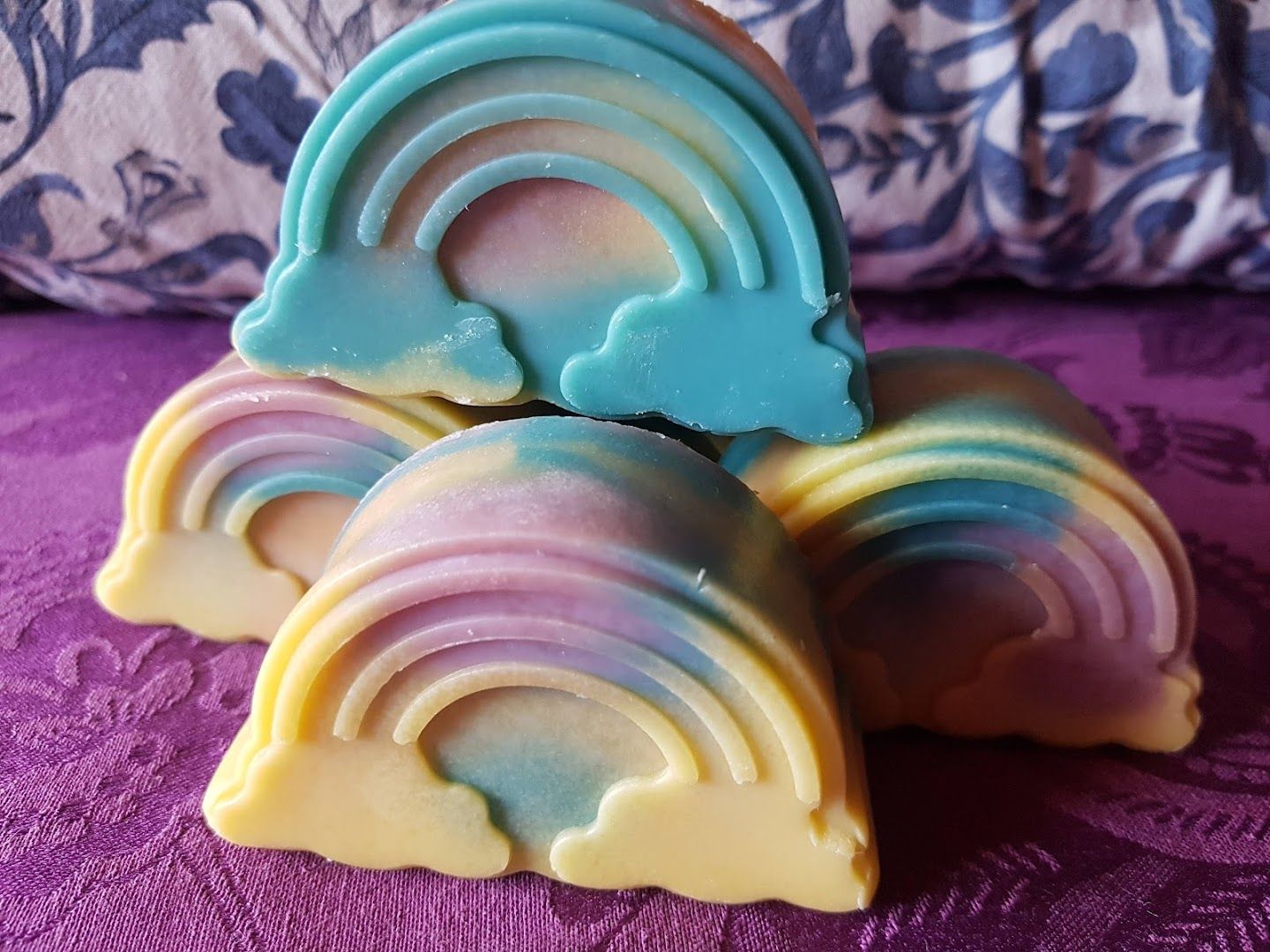 three soap bars with rainbow colored swirls