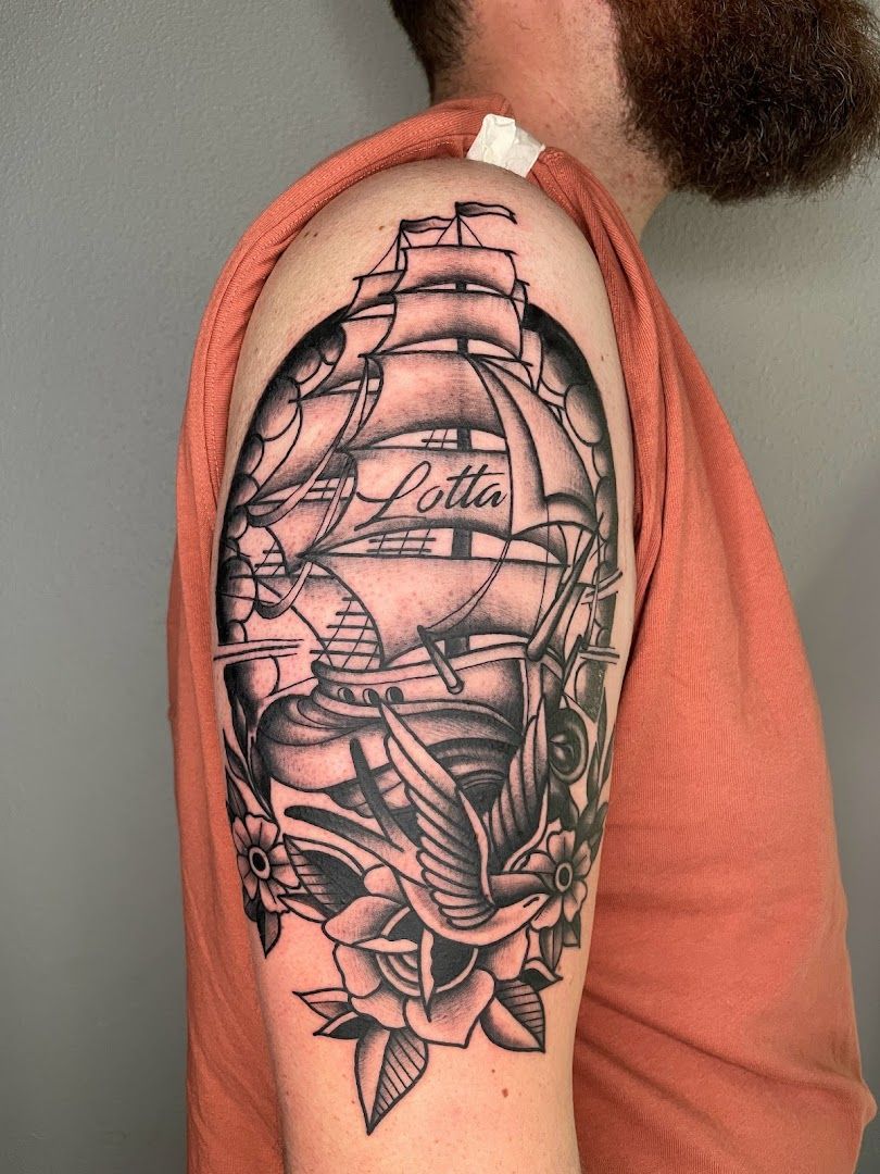 a black and white narben tattoo of a ship with a rose, freising, germany