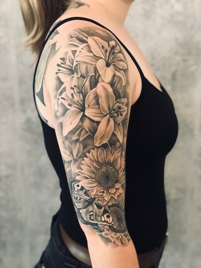 a woman with a black and white flower cover-up tattoo on her arm, bayreuth, germany