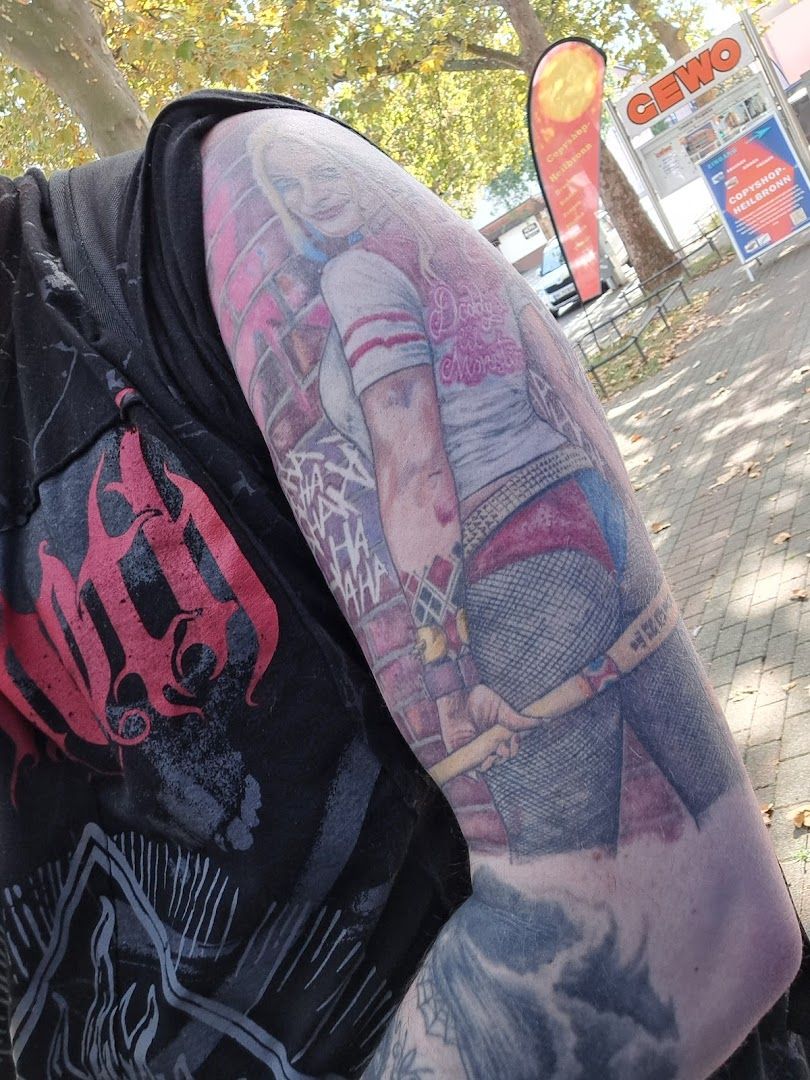 a man with a cover-up tattoo on his arm, tübingen, germany