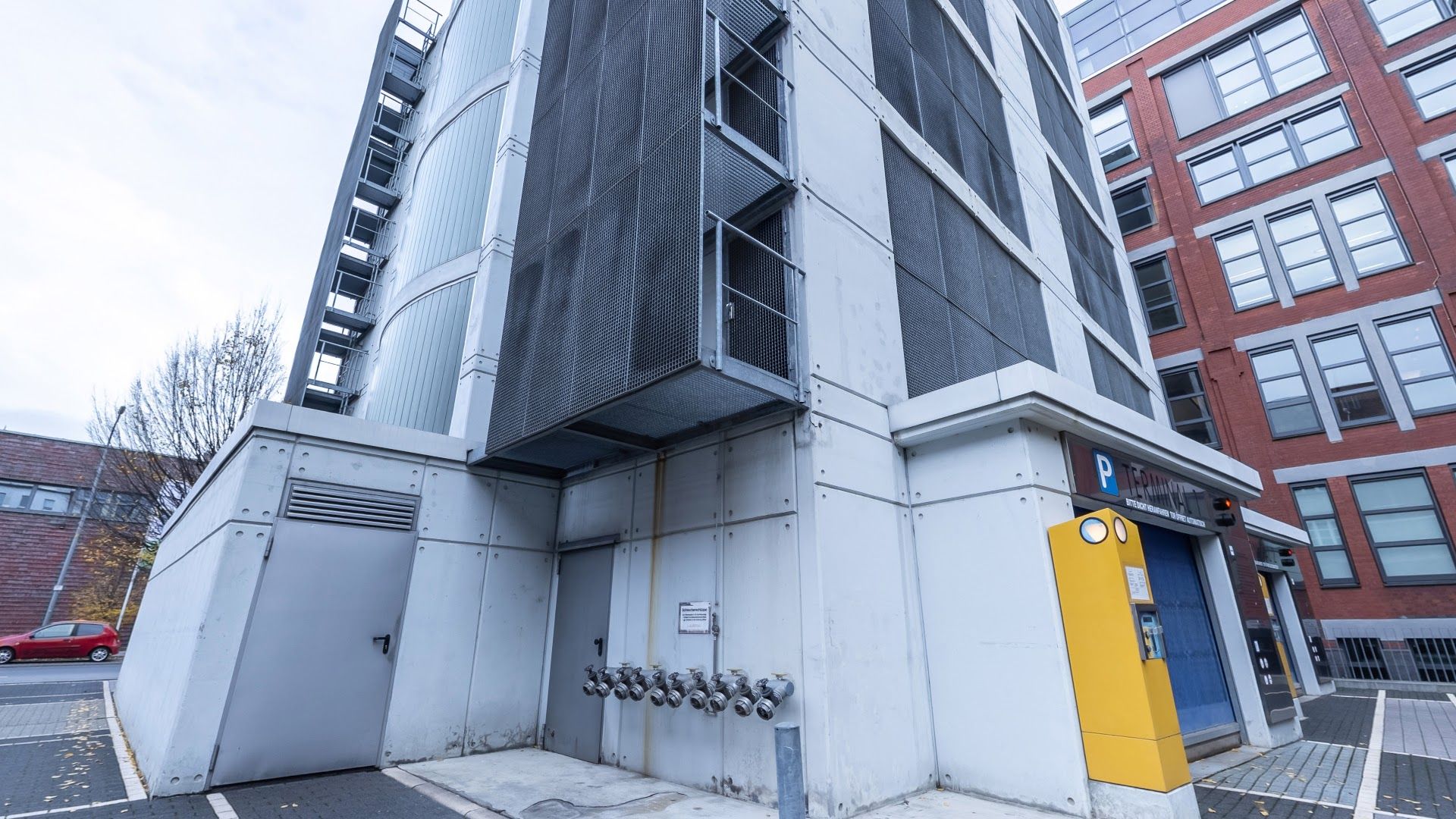 a building with a yellow door and a white wall