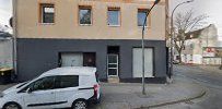 a white car parked in front of a building