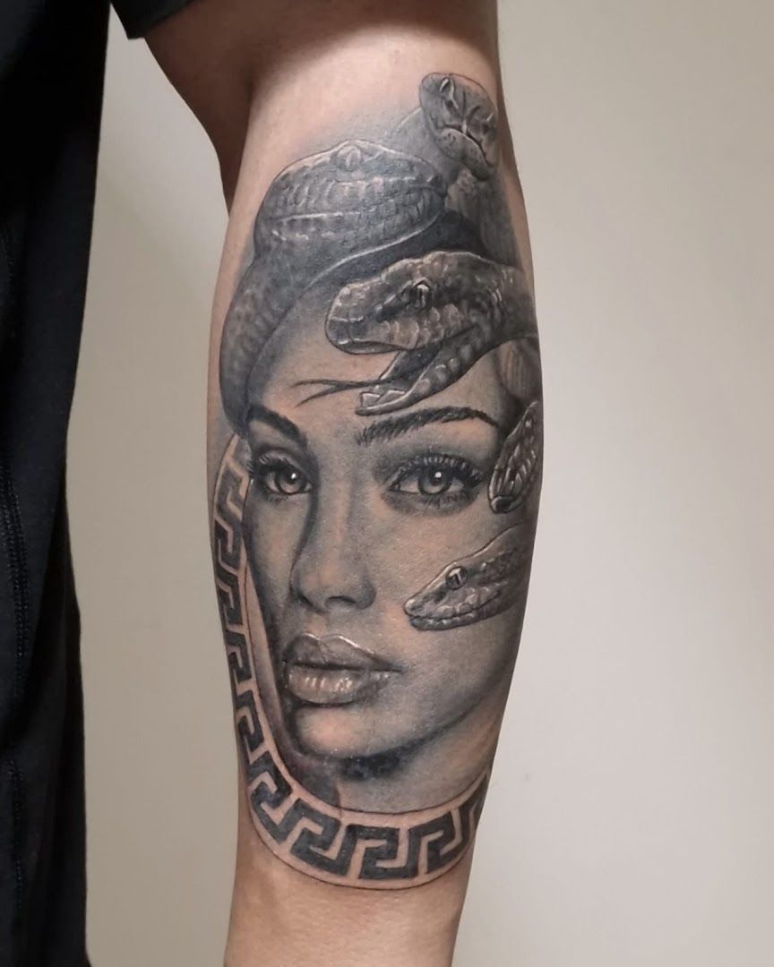 a woman with a snake on her arm